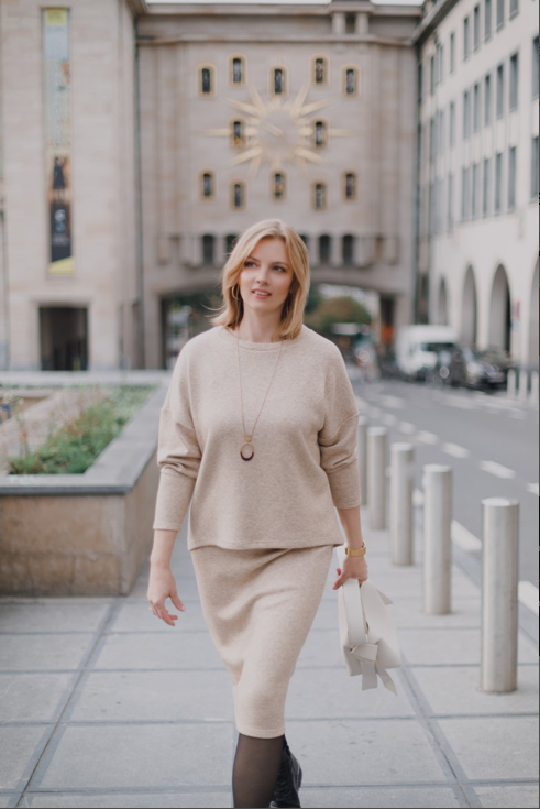 Woman wearing the Anna Skirt sewing pattern from Lenaline Patterns on The Fold Line. A skirt pattern made in stretch fabrics such as mesh, sweat, fleece sweat, fleece jersey or neoprene fabrics, featuring a high waist, straight silhouette, below knee leng