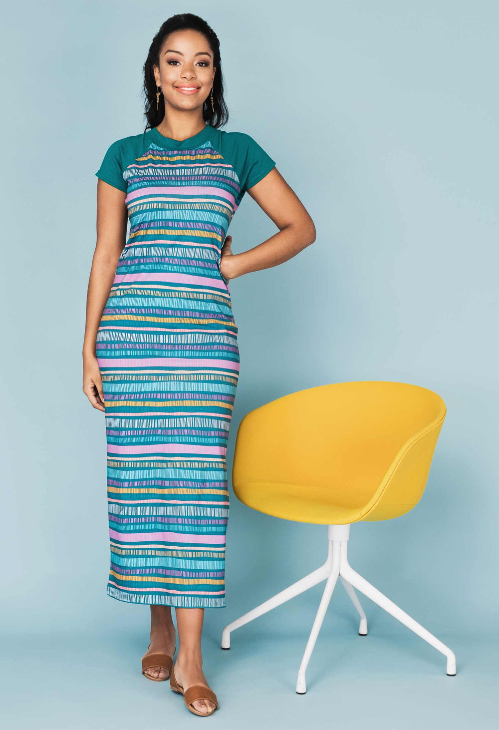 Woman wearing the Bellini Dress sewing pattern from Our Lady of Leisure on The Fold Line. A dress pattern made in jersey, double jersey or interlock fabrics, featuring short raglan sleeves, midi length, side slits, and crew neck.
