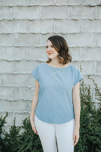 Woman wearing the Bondi Top sewing pattern from Sew To Grow on The Fold Line. A top pattern made in lawn, linen, rayon, voile or double gauze fabrics, featuring a curved hem, scoop neckline, short grown on sleeves and boxy fit.