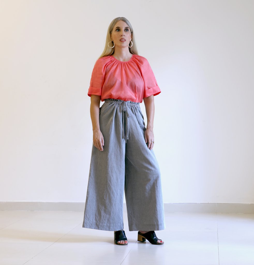 Woman wearing the Cove Pant sewing pattern from Pattern Fantastique on The Fold Line. A trouser pattern made in cotton, poplins, shirting, linens, silks twills, rayon and Tencel fabrics, featuring a high waist, back double yoke, paper bag style gathered f