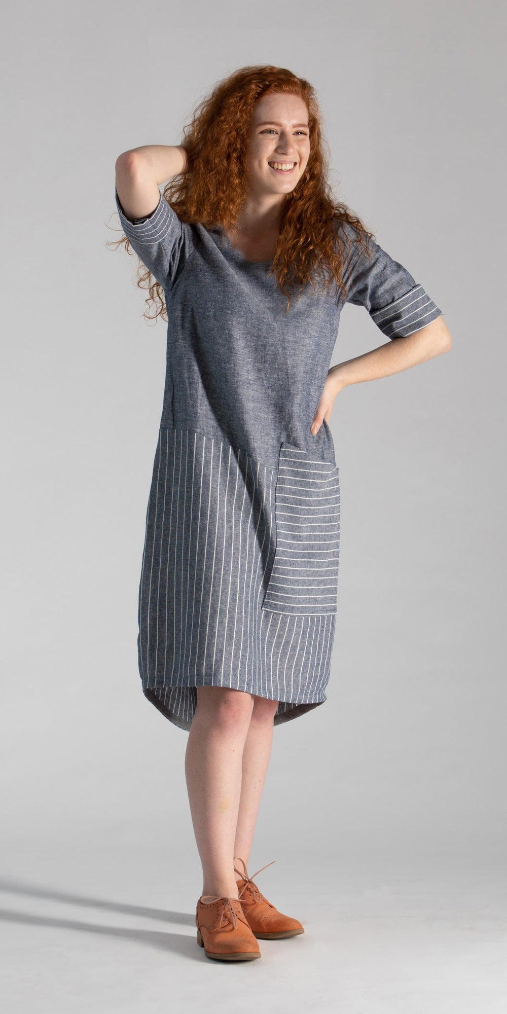Women wearing the Eclipse Dress sewing pattern from Sew Different on The Fold Line. A dress pattern made in linen, cotton, cotton blends, lightweight wool, stable jersey, viscose, and chambray fabrics, featuring a loose-fit, bubble shape, front oversized 