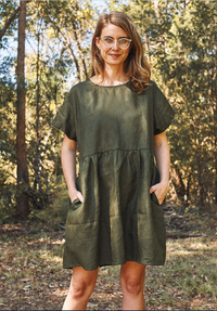 Woman wearing the Fawn Dress sewing pattern by Common Stitch. A dress pattern made in cotton or linen fabrics, featuring short sleeves, above knee length, two front pockets and relaxed fit.