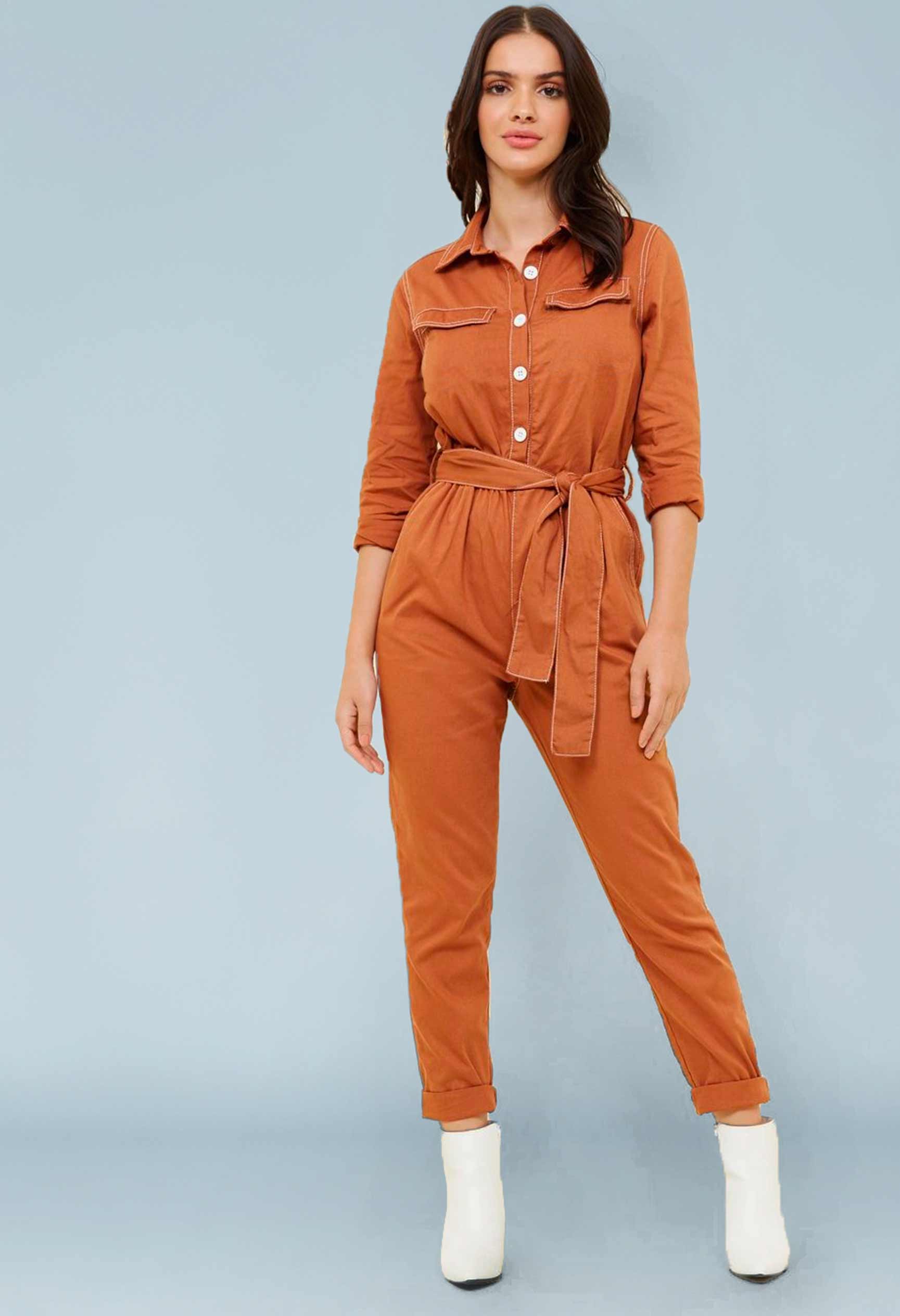 Woman wearing the Gimlet Boilersuit sewing pattern from Our Lady of Leisure on The Fold Line. A boilersuit pattern made in broadcloth, twill, canvas, denim or satin fabrics, featuring hip pockets, faux breast pockets, buttoned bodice closure, loose fit, t