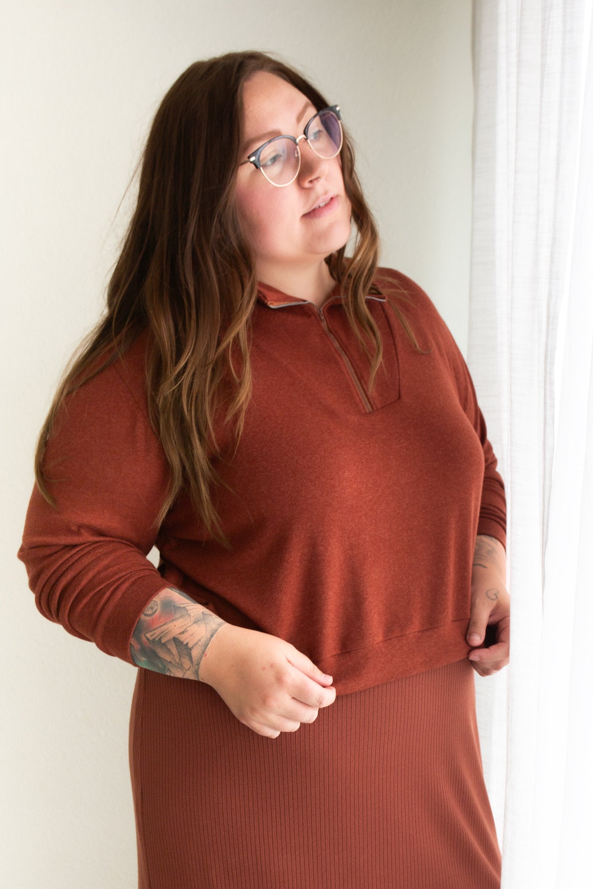 Woman wearing the Hive Pullover sewing pattern from Allie Olson on The Fold Line. A top pattern made in French terry, sweatshirt fleece, or sweater knit fabric, featuring a boxy fit, dropped shoulders, angled front yoke with a centre front zipper, cuffed 