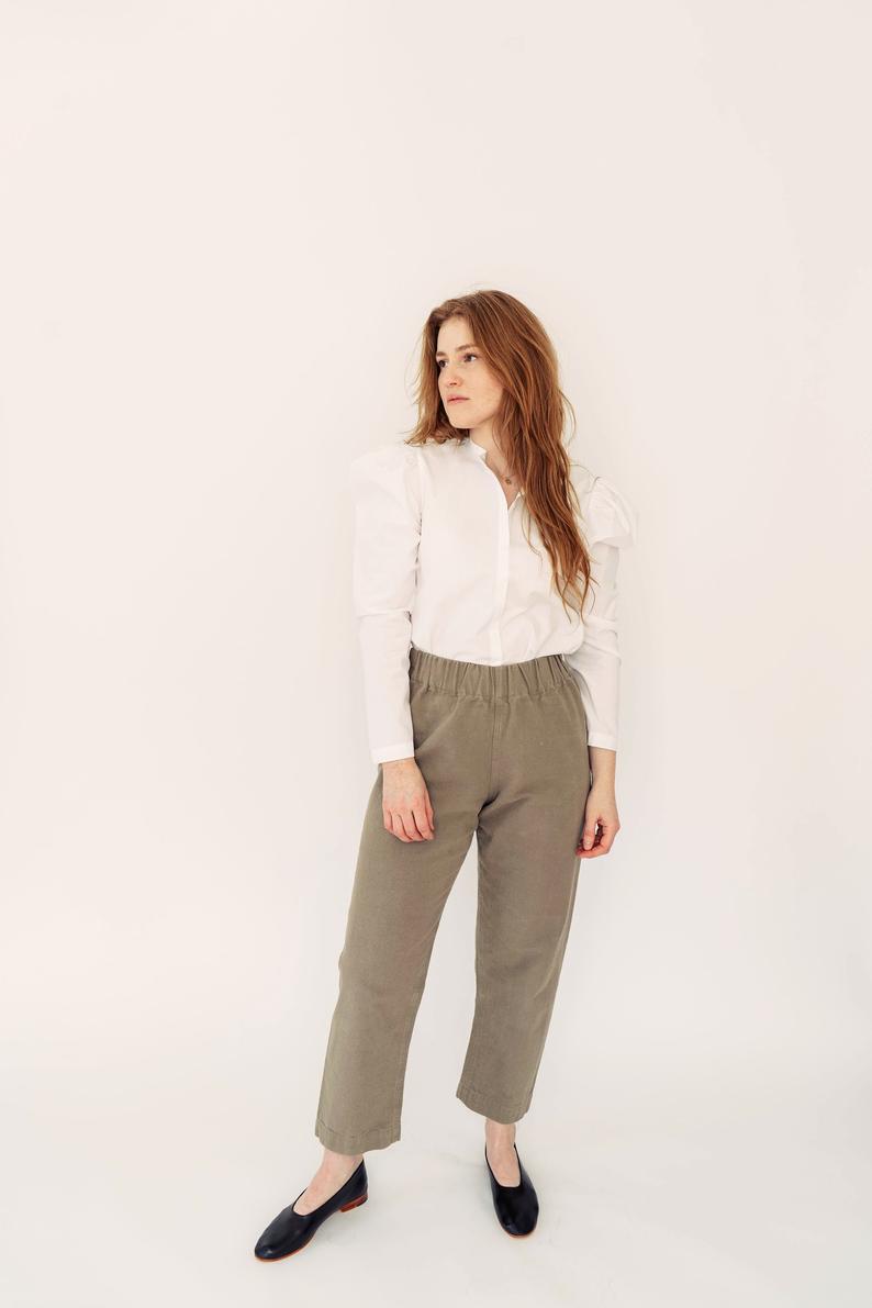 Woman wearing the Pomona Pants sewing pattern by Anna Allen. A trouser and shorts pattern made in cotton canvas, twill, medium to heavy weight linen or wool suiting fabrics, featuring an elastic waist, high rise, loose fit and patch pockets.