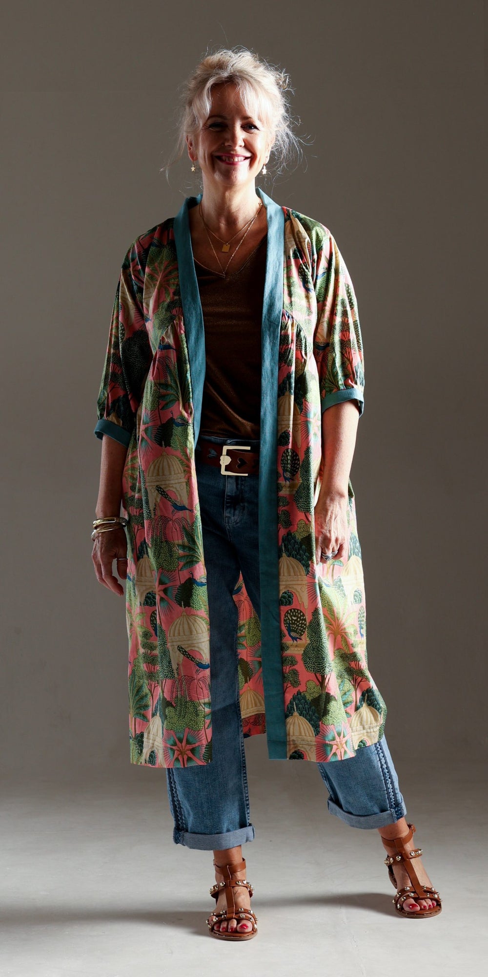 Woman wearing the Joti Duster Jacket sewing pattern from Sew Different on The Fold Line. A duster jacket pattern made in lightweight cotton, viscose, rayon or lightweight linen fabrics, featuring a relaxed fit, midi length, back yoke, in-seam pockets, dro