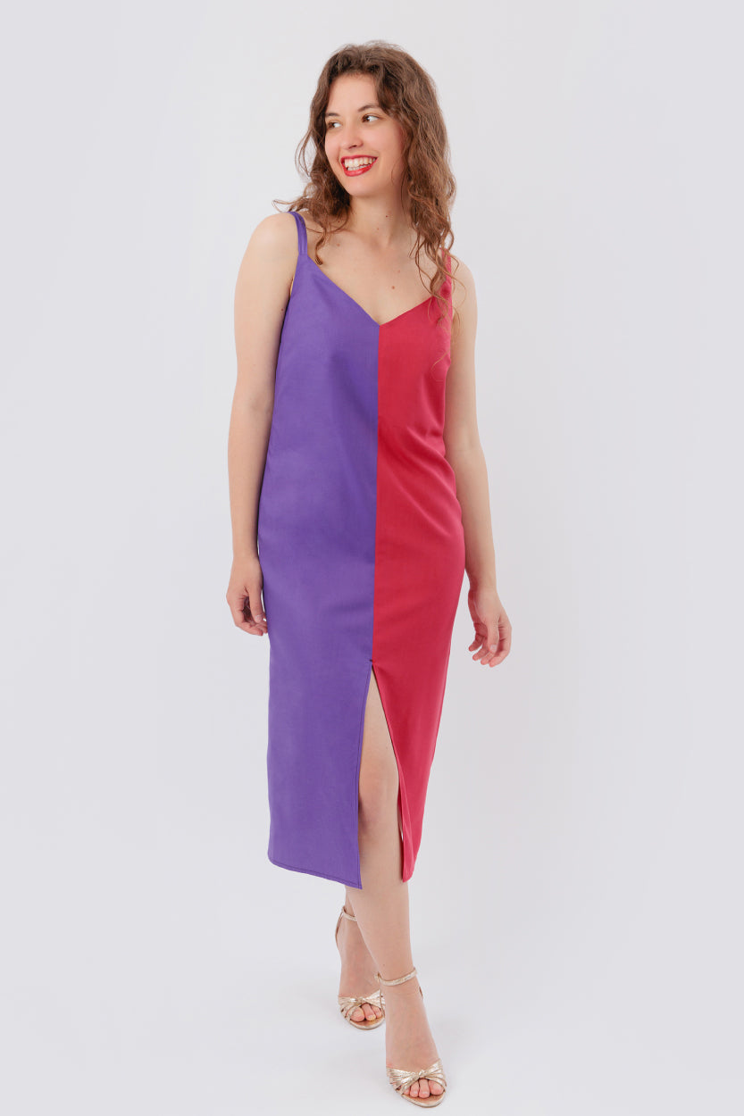 Woman wearing the Free Kaia Dress sewing pattern from Sew Love Patterns on The Fold Line. A dress pattern made in cotton, viscose, tencel, crepe, rayon, linen and bamboo silk fabrics, featuring a midi length, front slit, deep front and back V-neck, spaghe