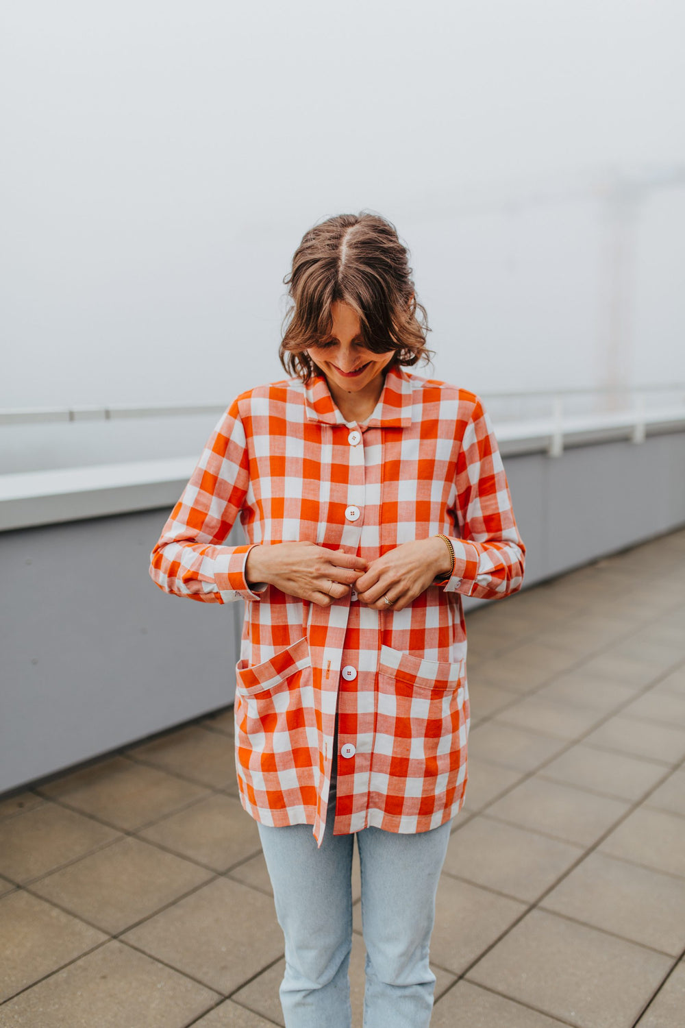 Woman wearing the Jameela Jacket sewing pattern from Sewing Patterns by Masin on The Fold Line. A jacket pattern made in canvas, thick denim, corduroy, twill, wool, or jacquard fabrics, featuring a hip length, unlined, two large welt front pockets, back y