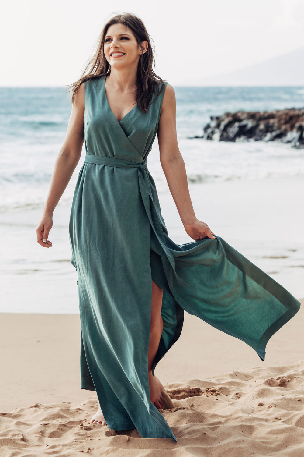 Woman wearing the Highlands Wrap Dress sewing pattern from Allie Olson on The Fold Line. A dress pattern made in rayon/linen blends, rayon challis, tencel, crepe de chine, or georgette fabric, featuring a sleeveless wrap silhouette, faced V-neckline, elas