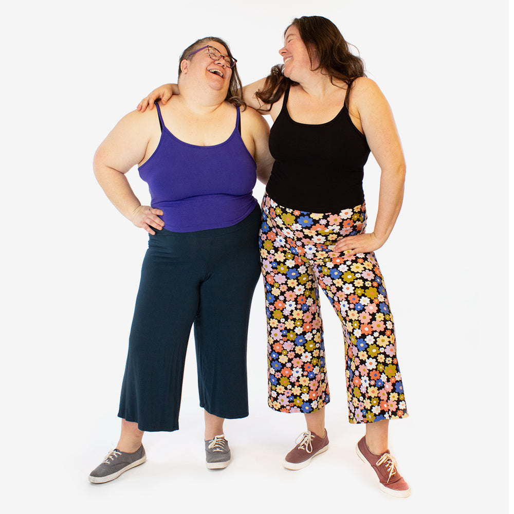 Women wearing the Nelson Pants sewing pattern from Helen’s Closet on The Fold Line. A pants pattern made in bamboo jersey, modal jersey, or stretchy athletic knit fabric, featuring a soft fabric waistband, snug fit through the waist and hip, loose fit thr