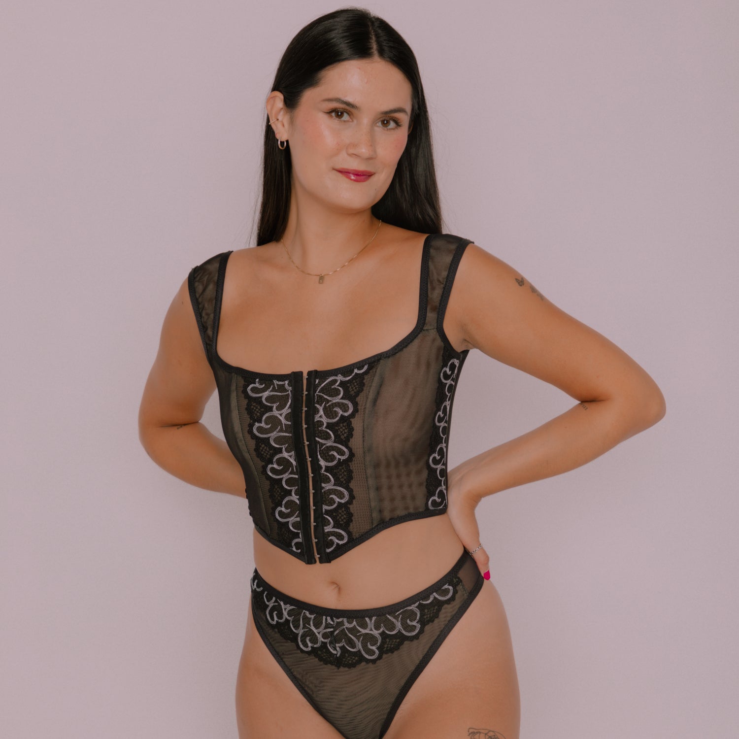 Woman wearing the Free Odessa Corset Top and Panty sewing pattern from Madalynne on The Fold Line. A corset top and panty pattern made in stretch mesh, stretch all over lace, jersey, and lycra fabrics, featuring fold over elastic, channelling, plastic bon