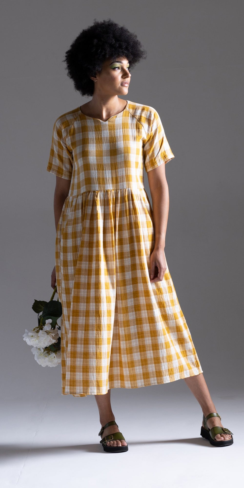 Women wearing the Ripple Dress sewing pattern from Sew Different on The Fold Line. A dress pattern made in viscose, crepe, cotton lawn, and lightweight linen fabrics, featuring a loose-fit, peasant-style, boxy bodice with notched neckline, elbow-length ra