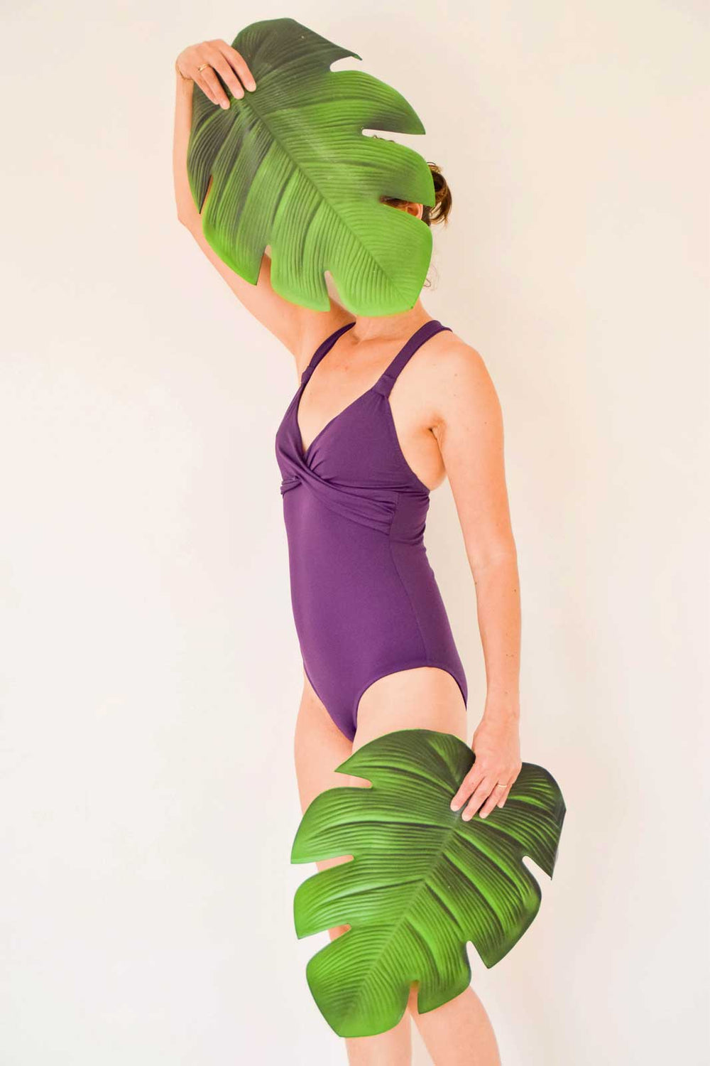 Woman wearing the Sangria Swimsuit sewing pattern from Fitiyoo on The Fold Line. A swimsuit pattern made in swimsuit fabrics, featuring a plunging neckline, underbust drape, wide adjustable shoulder straps, low/medium rise leg and full/medium back coverag
