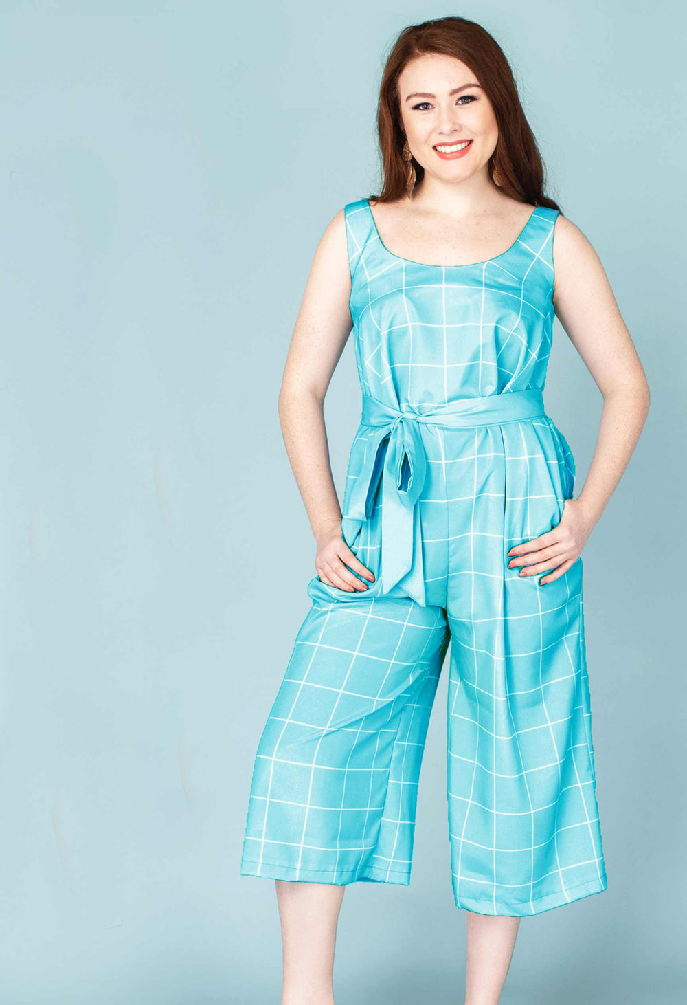 Woman wearing the Sangria Jumpsuit sewing pattern from Our Lady of Leisure on The Fold Line. A jumpsuit pattern made in lightweight cottons, linens, synthetics and rayon fabrics, featuring a relaxed fit, deep scoop neck, sleeveless, palazzo style midi len