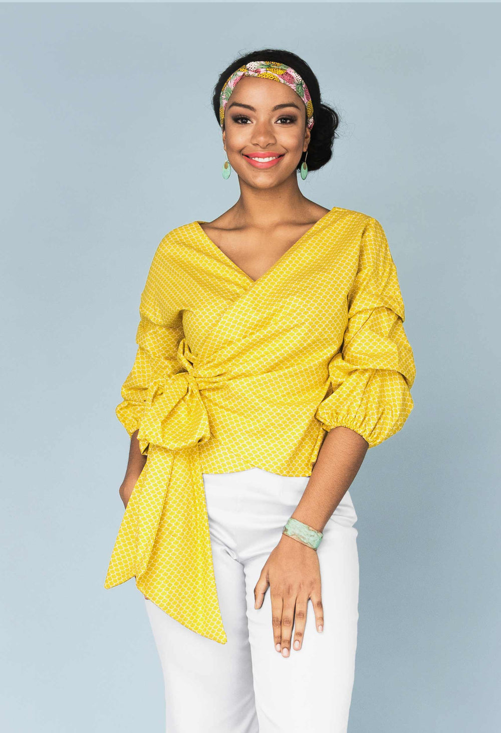 Woman wearing the Screwdriver Top sewing pattern from Our Lady of Leisure on The Fold Line. A wrap blouse pattern made in lawn, poplin, broadcloth and quilting cotton fabrics, featuring a wrap closure with very large bow, V-neck, ¾ length origami sleeves 