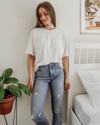 Woman wearing the Unisex Tulia Tee sewing pattern from Sewing Patterns by Masin on The Fold Line. A T-shirt pattern made in cotton jersey, viscose jersey or merino wool jersey fabrics, featuring an oversized fit, round neck, grown-on elbow length sleeves 