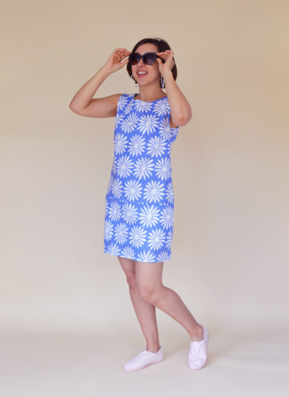 Woman wearing the Carnaby Dress sewing pattern from Nina Lee on The Fold Line. A sleeveless shift dress pattern made in lightweight denim, corduroy, lightweight wool, cotton sateen or chambray fabrics, featuring in-seam pockets, exposed zip at the centre back, round neck and mini length finish.