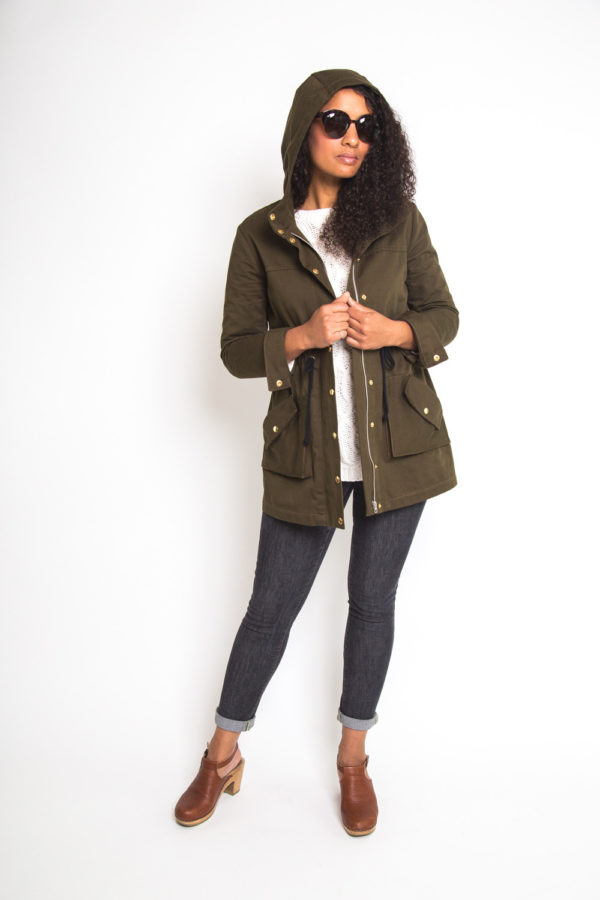 Woman wearing the Kelly Anorak Jacket sewing pattern by Closet Core Patterns. An anorak jacket pattern made in Twill, gabardine, linen, ripstop or Gore-Tex fabric featuring a optional drawstring waist, razor placket with snap buttons, a roomy hood and pockets.