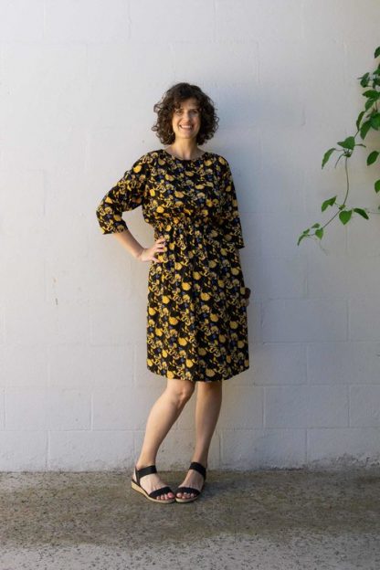 Woman wearing the Lou Box Dress 2 sewing pattern from Sew DIY on The Fold Line. A dress pattern made in lightweight knit or woven fabrics, featuring a loose fit, gathered elastic waist, ballet neckline, scoop pockets and ¾ length dolman sleeves.