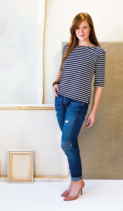 Woman wearing the Maritime Knit Top sewing pattern from Liesl + Co on The Fold Line. A knit top pattern made in jersey, double knit, thermal knit, and interlock fabrics, featuring a pull-on style, three-quarter-length sleeves, bateau neck with topstitching, and side vents.