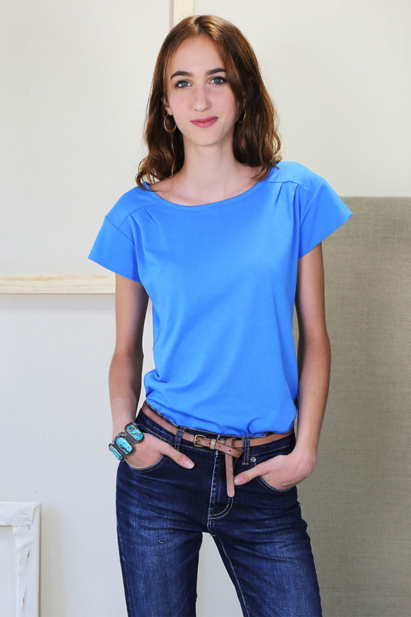 Woman wearing the Chai Tee sewing pattern from Liesl + Co on The Fold Line. A T-shirt pattern made in lightweight cotton knit fabrics, featuring a pull-on style, relaxed fit, shoulder yokes, shoulder pleats, short sleeves and bust cup options.