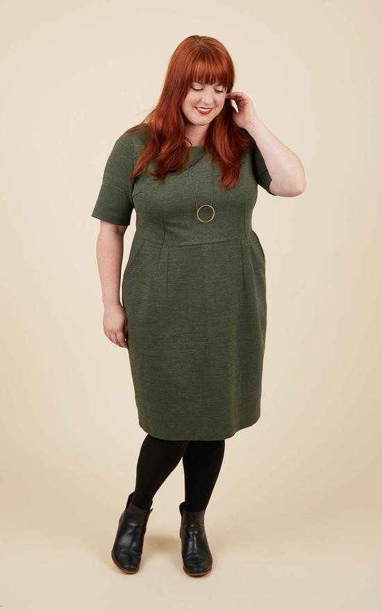 Woman wearing the Rivermont Dress sewing pattern by Cashmerette. A fitted sheath dress pattern made in mid-weight ponte knit or lightweight scuba/neoprene fabric featuring a knee length, slash pockets, elbow length sleeves and a round neckline.