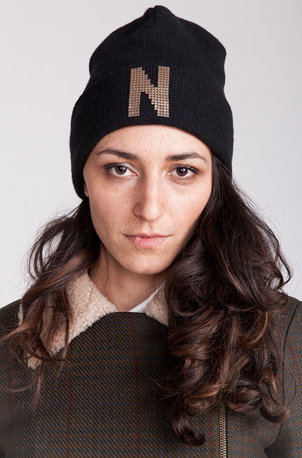 Woman wearing the Delia Beanie sewing pattern from Named on The Fold Line. A hat pattern made in a thick knit or jersey fabrics, featuring a pull-on style and deep turned back brim.