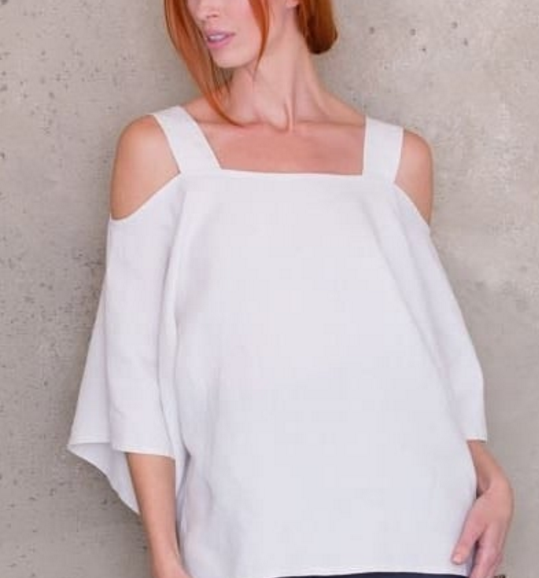Woman wearing the Cold Shoulder Tunic Top sewing pattern by Ann Normandy. A tunic top pattern made in light to medium weight linen fabric, featuring a square neckline, relaxed fit, bell sleeves and side vents.