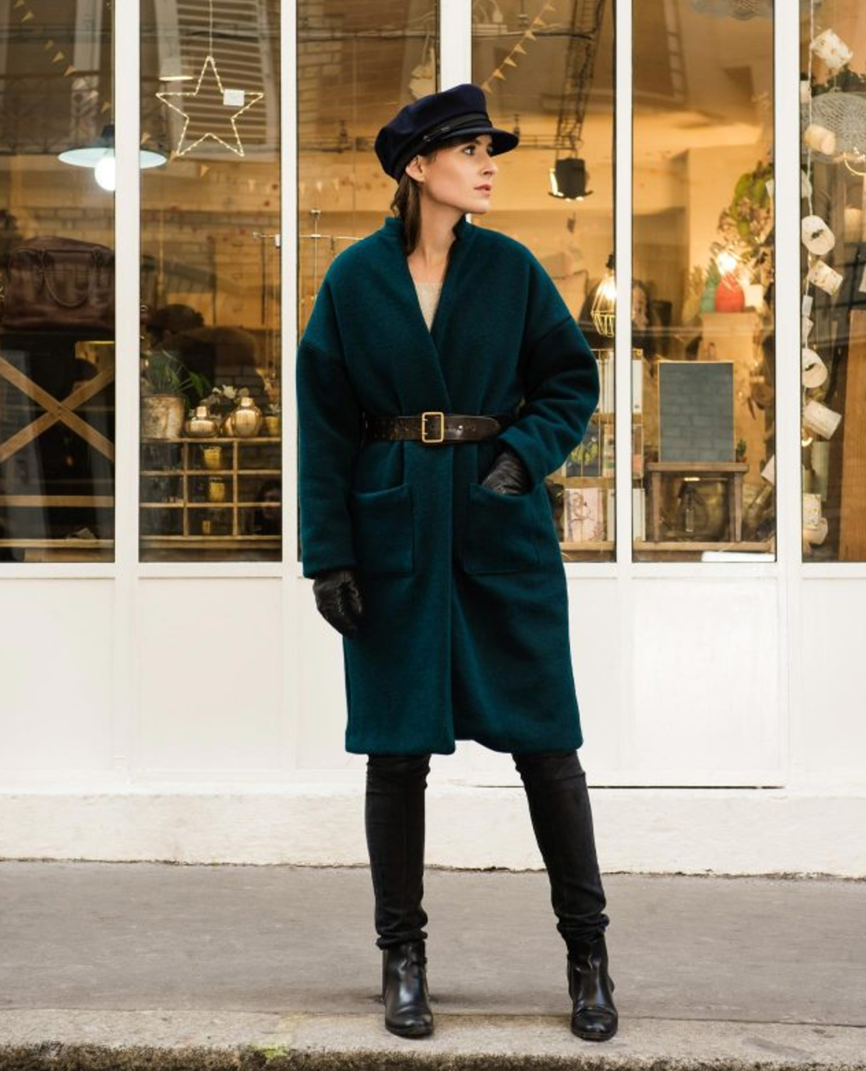Woman wearing the Riga Coat sewing pattern from Orageuse on The Fold Line. A coat pattern made in wool, broadcloth or tweed fabrics, featuring a stand collar, relaxed fit, dropped shoulders, front patch pockets, full length sleeves and knee length finish.