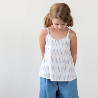 Girl wearing the Children’s Mini Ogden Cami sewing pattern by True Bias. A camisole pattern made in cotton voile, cotton lawn, linen or double gauze fabric featuring a soft V neck and spaghetti straps over each shoulder.