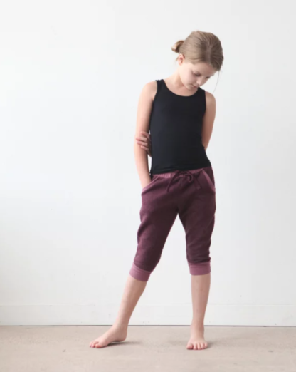 Girl wearing the Mini Hudson Pant sewing pattern by True Bias. A skinny sweatpant pattern made in cotton lycra, French terry, ponte or sweatshirt knit fabric featuring an elastic waistband with drawstring, pockets and cuffs.