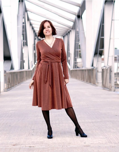 Woman wearing the Wanda Wrap Dress sewing pattern from Wardrobe by Me on The Fold Line. A wrap dress pattern made in light weight jersey fabrics, featuring a six-gore skirt, full length sleeves, V-neckline, and knee length hem.