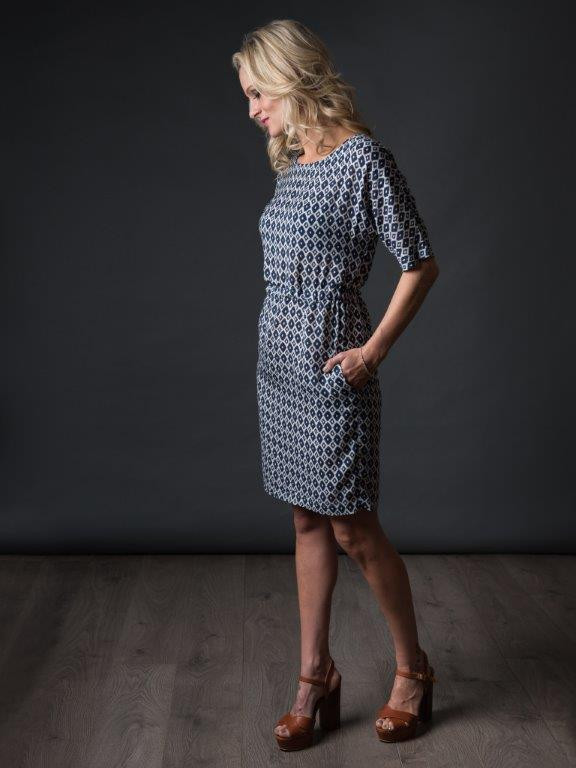 Woman wearing The Sheath Dress sewing pattern from The Avid Seamstress on The Fold Line. A dress pattern made in light to medium weight fabrics, featuring a round neckline, grown-on sleeves, in-seam pockets, elasticated waist and above knee length hem.