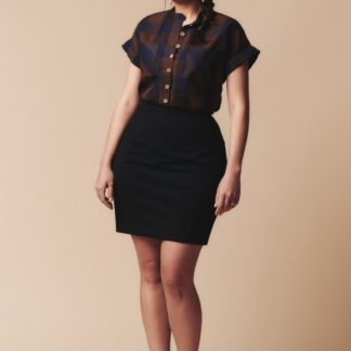 Woman wearing the Brume Skirt sewing pattern by Deer and Doe. A mini, pencil skirt pattern made in medium-weight knit fabric featuring a high waist and waist band.
