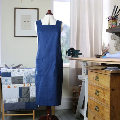 Mannequin wearing the Hepworth Apron sewing pattern by Jenni Smith. An apron pattern made in cotton, linen or denim fabrics featuring front pockets and cross over back straps.