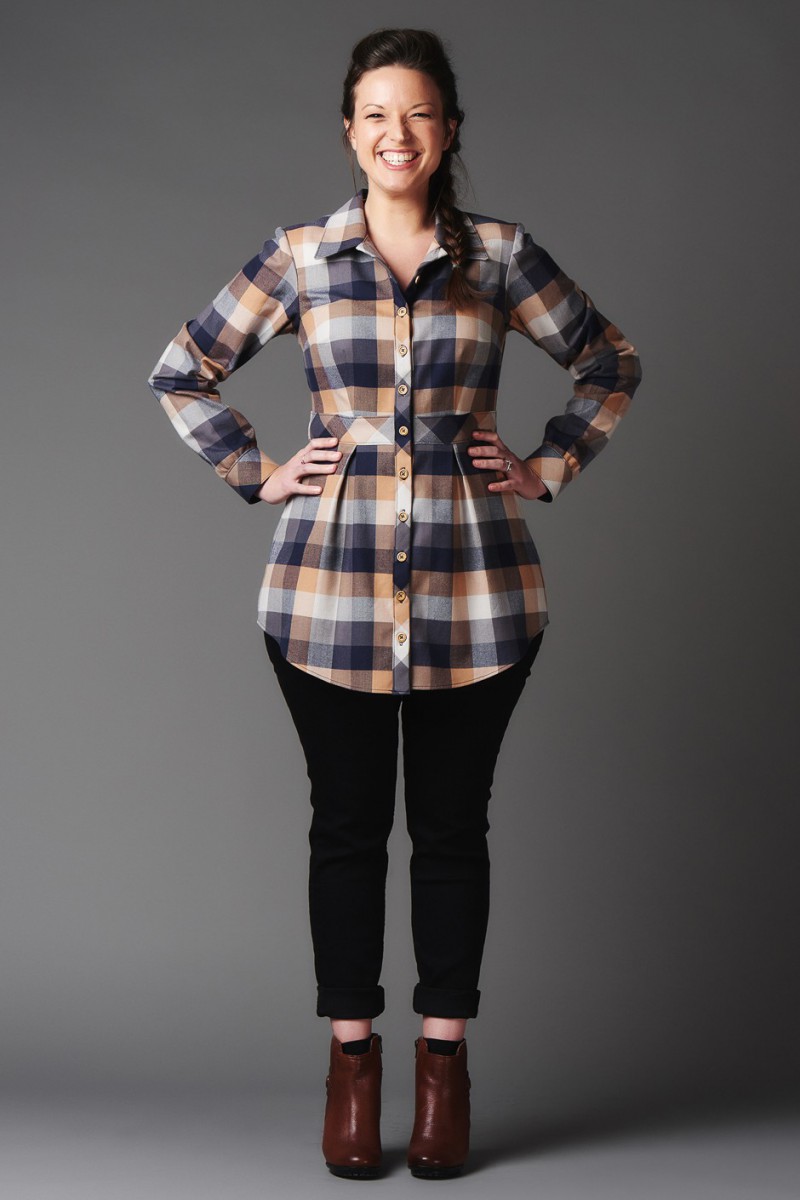 Woman wearing the Bruyere Shirt sewing pattern by Deer and Doe. A tunic-length, button up shirt pattern made in batiste, cotton satin, chambray or linen fabric featuring long sleeves, a cinched waist, flat collar, gathered sleeve cuffs and a back yoke.