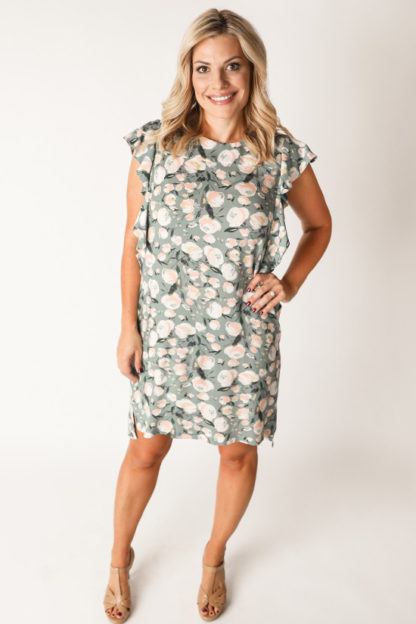 Woman wearing the Farrah Dress sewing pattern by Chalk and Notch. A dress pattern made in rayon’s, cotton’s, linen or double gauze fabrics, featuring ruffled sleeves, side slit, high-low hem detail and jewel neckline.