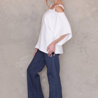 Woman wearing the Pant sewing pattern by Ann Normandy. A trouser pattern made medium to heavy weight linen, denim, cotton twill or raw silk fabrics, featuring a side zipper, deep welt pocket, and shaped waistline. They are fitted around the hips and have a straight leg.