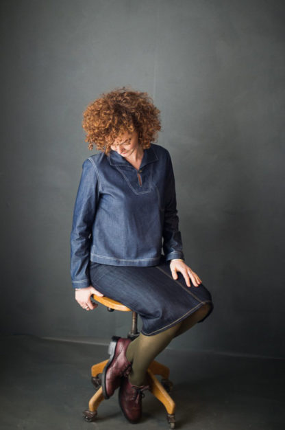 Woman wearing the Francine Top sewing pattern by Merchant and Mills. A top pattern made in denim, cotton chambray, linen or corduroy fabric featuring a slim fit, inside breast pocket, side slits, collar and front single button closure.
