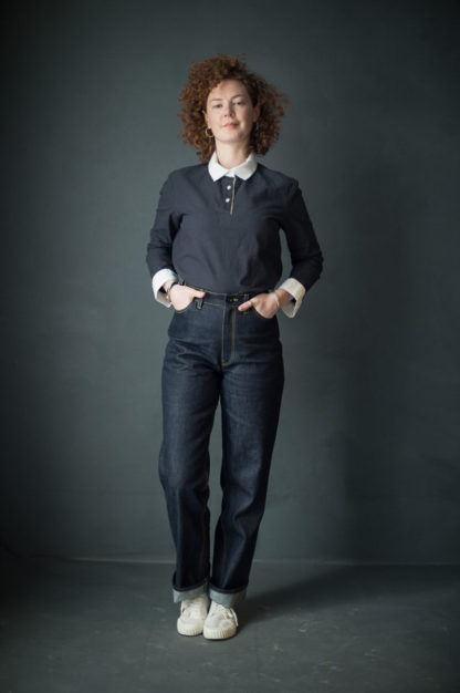 Woman wearing the Heroine Jeans sewing pattern by Merchant and Mills. A jeans pattern made in non-stretch denim fabric featuring a straight leg, turn ups, topstitching, fly zip and front and back pockets.