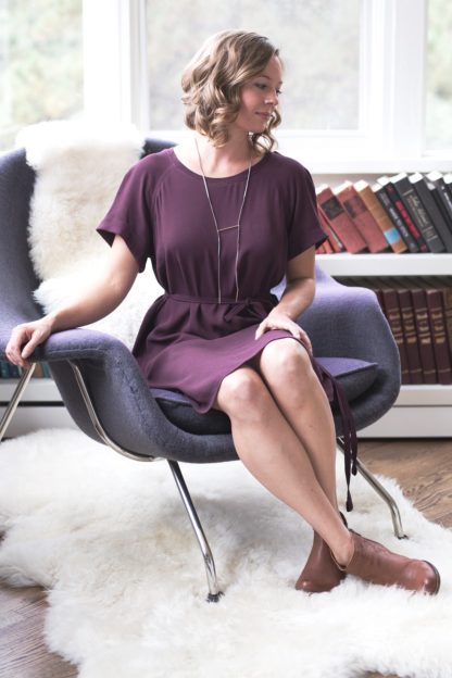 Woman wearing the Coram Dress sewing pattern by Allie Olson. A loose fitting dress pattern made in mid-weight woven fabrics such as rayon/linen blends, rayon challis, tencel, crepe de chine or georgette fabrics, featuring short raglan sleeves, knee length finish and round neckline.