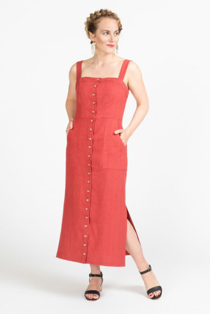 Woman wearing the Fiona Sundress sewing pattern by Closet Core Patterns. A sleeveless, fitted dress pattern made in denim, twill, chambray or linen fabric featuring a button front, shoulder straps, princess seams, and pockets.