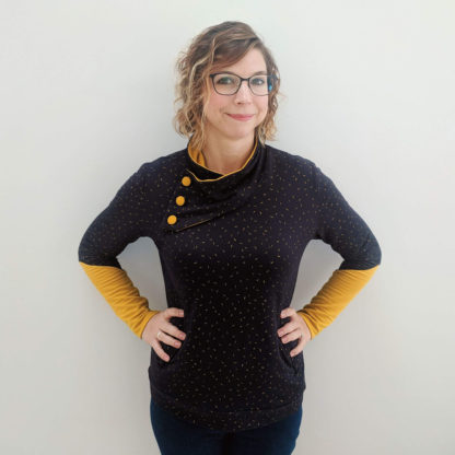 Woman wearing the Casey Sweater sewing pattern by Experimental Space. A jumper pattern made in french terry, sweatshirt or any medium weight knit material with a bit of stretch, featuring a button detail at the neck, long shaped cuffs and deep pockets.