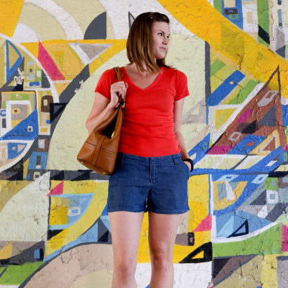 Woman wearing the Chi-Town Chinos sewing pattern by Alina Sewing and Design Co. A shorts pattern made in cotton twill, chambray, denim, linen or wool fabric featuring a mid-rise, waistband, belt loops, fly zipper, and front pockets.