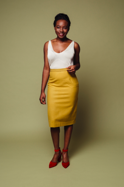 Woman wearing the Josephine Skirt sewing pattern from Melilot on The Fold Line. A pencil skirt pattern made in cotton, wool, suiting or jacquard/brocade fabrics, featuring a fitted silhouette, front and back waist darts, straight waistband, centre back zip closure, centre back split and just below knee length hem.