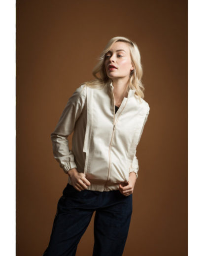Woman wearing the Cèdre Jacket sewing pattern from Orageuse on The Fold Line. A bomber jacket pattern made in canvas, denim, satin, velvet, serge, tweed, jacquard or wax fabrics, featuring a straight fitting silhouette, elasticated waist and cuffs, zipper at the centre front, high collar and front pockets.