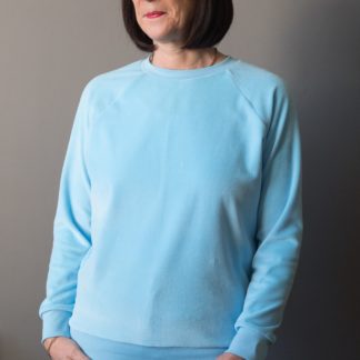 Woman wearing the Lynn Sweatshirt sewing pattern by Bobbins and Buttons. A sweatshirt pattern made in sweatshirt fabrics, stable knits, stretch velvet or lighter weight jersey fabrics, featuring a long raglan sleeve and rib trim on the neck, cuff and hem bands.