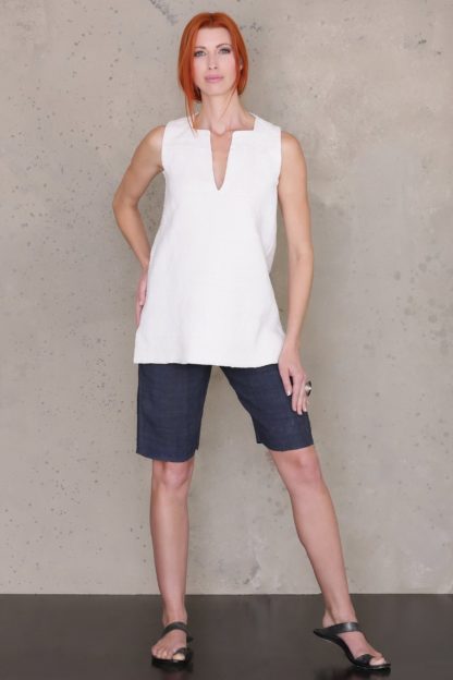 Woman wearing the Bermuda Shorts sewing pattern by Ann Normandy. A shorts pattern made in medium to heavy weight linen, denim, cotton twill or raw silk fabrics, featuring a side zipper, deep welt pocket and shaped waistline.
