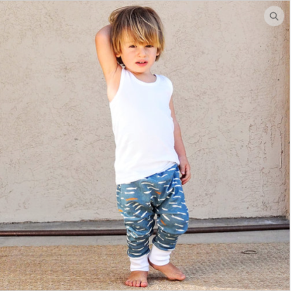 Child wearing the Child/Baby Basic Joggers sewing pattern from Elemeno Patterns on The Fold Line. A jogger pattern made in cotton knit fabrics, featuring a roomy fit, full length leg with ankle cuffs and waistband.