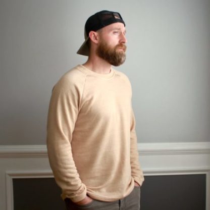 Man wearing the Ryan Raglan sewing pattern from 5 out of 4 Patterns on The Fold Line. A jumper pattern made in 2-way or 4-way medium weight knit fabric with at least 50% horizontal stretch such as brushed poly, cotton Lycras, or bamboo Lycra fabrics, featuring full length raglan sleeves, crewneck and relaxed fit.